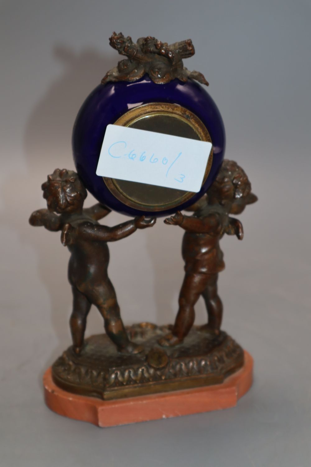 A French porcelain and bronze putti mantel clock, with diamonte decoration to the dial, height 20cm